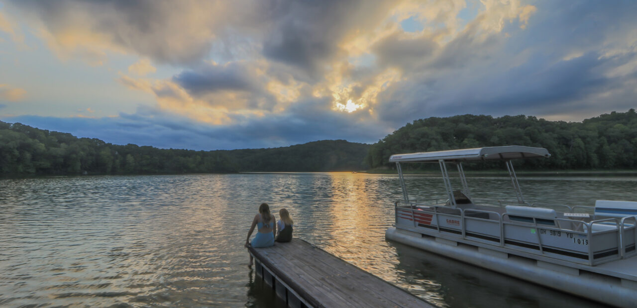 Two girls sitting on the dock of the bay