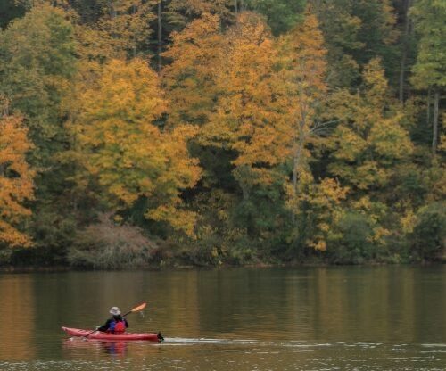 Kayaker on lake in the Fall