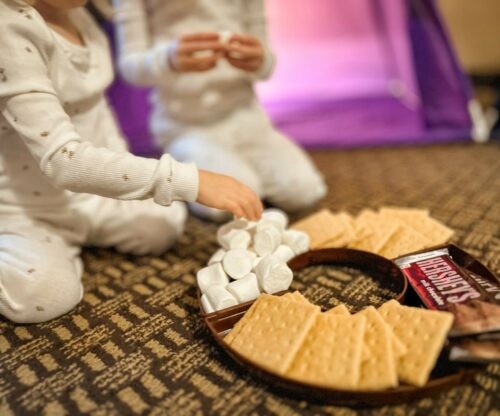 Two young girls enjoy a smores kit while glamping at burr oak lodge