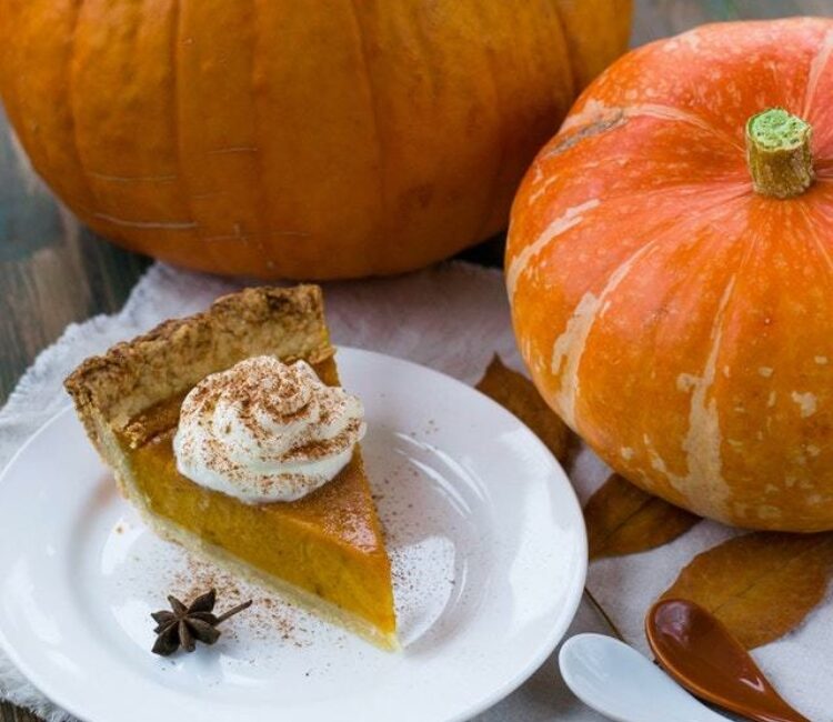 Pumpkins next to a piece pumpkin pie