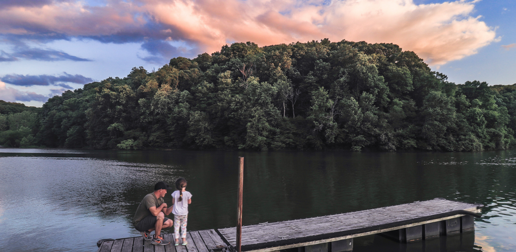 Father and daughter fishing at sunrise