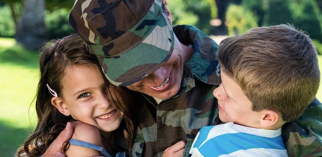 Service Member hugging children